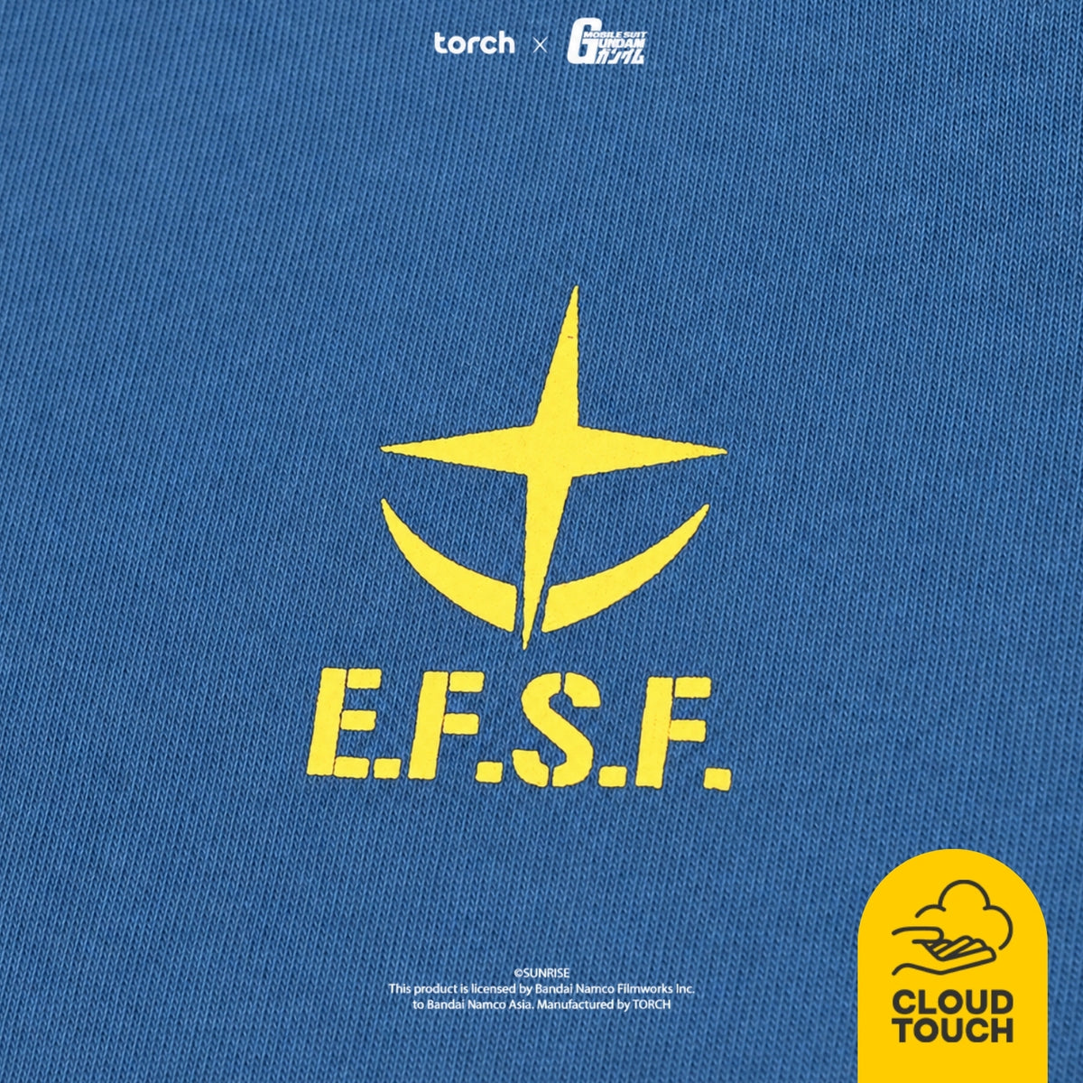 Close-up of a blue textured fabric with a large yellow E.F.S.F